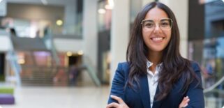 Student wearing a dar blue suit and glasses